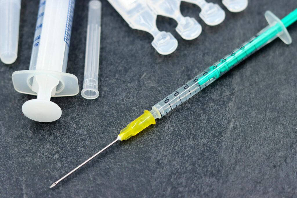 pexels photo 24032781 24032781 Detailed image of a syringe and medical supplies, ideal for healthcare and vaccination themes.