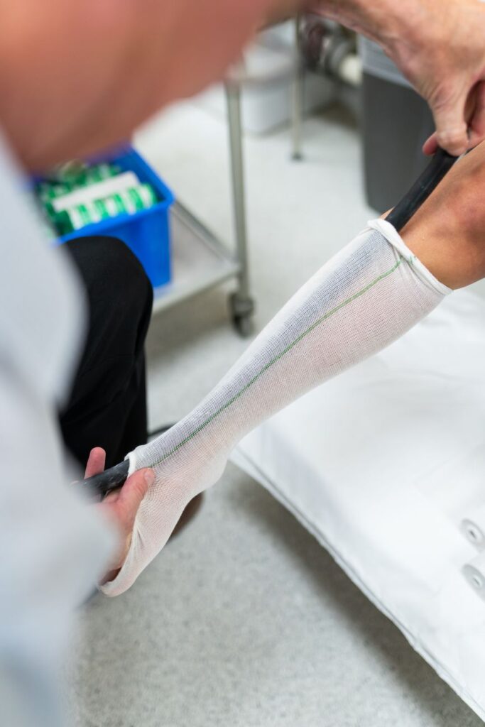 pexels photo 3913018 3913018 Orthotic technician measuring patient's leg for custom orthotic in a healthcare setting.